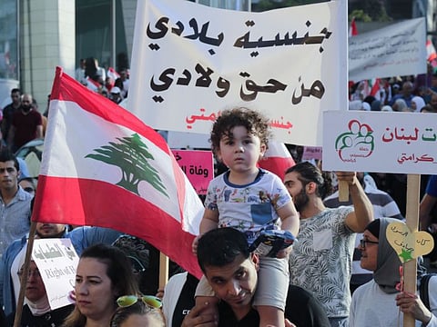 Lebanese demonstrators take part in a march entitled "My Nationality, My Dignity" in the centre of the capital Beirut on November 10, 2019, calling for giving Lebanese women the right to transmit the nationality to their children.