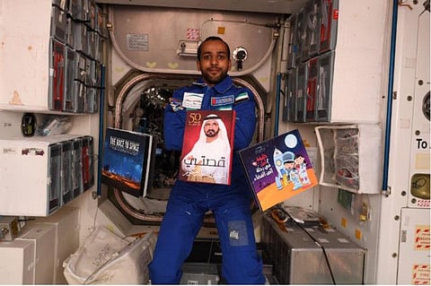 Hazzaa Al Mansouri with his three favourite books onboard the International Space Station last month