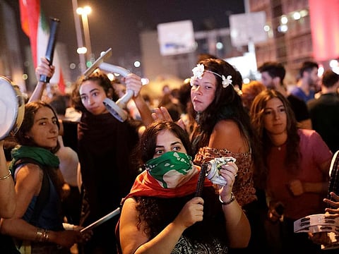 Protesters use objects to make noise at a demonstration following a broadcasted interview by Lebanese President Michel Aoun, during ongoing anti-government protests in Beirut, Lebanon November 12, 2019.