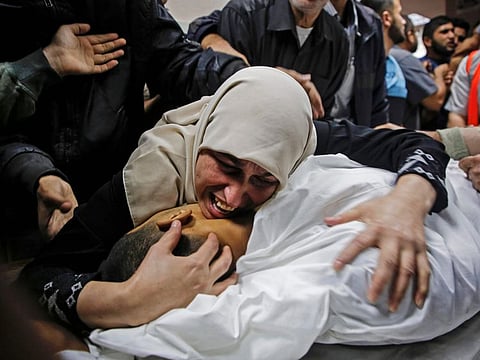 The mother of Palestinian Zaki Ghanama, 25, mourns over his body at the morgue of a hospital in Beit Lahia in the northern Gaza Strip on November 12.