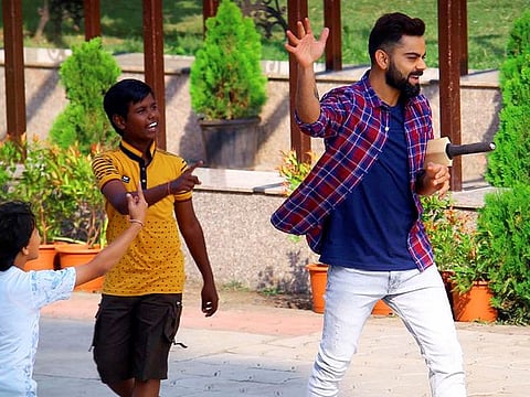 India skipper Virat Kohli smiles with kids during the shooting of a commercial in Indore, Tuesday.