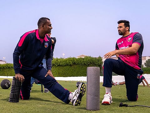 Sri Lanka's Angelo Mathews with India's Zaheer Khan during Delhi Bulls practice session at the ICC Academy.