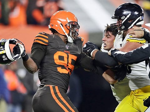 Browns DE Myles Garrett gets ready to hit Steelers quarterback Mason Rudolph with a helmet.