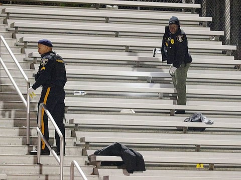 Pleasantville police search the stands after a shooting that occurred during a football game at Pleasantville High School in Pleasantville, N.J., Friday, Nov. 15, 2019.