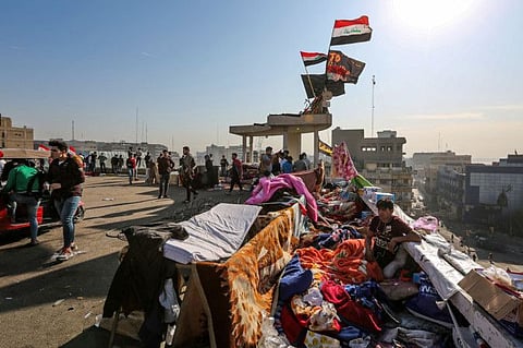 This picture taken on November 17, 2019 shows a view of quarters used by Iraqi anti-government protesters to sleep atop the roof of a garage building overlooking another sit-in near barricades along al-Sinek bridge connecting the Iraqi capital Baghdad's Sinek district to the Salhiyeh district neighbouring the high-security Green Zone, which hosts government offices and foreign embassies.