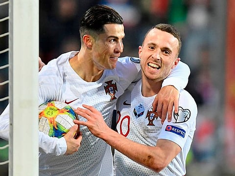 Cristiano Ronaldo (L) celebrates after scoring a goal during the Euro 2020 qualification match between Luxembourg and Portugal.