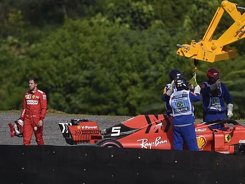 Sebastian Vettel walks away from his damaged car in Brazil.