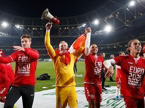 Denmark's Kasper Schmeichel celebrates with Martin Braithwaite and teammates after the match.