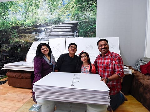 Manoj Varghese along with his wife Susan K. Samuel, daughter Krupa Sara Manoj and son Karun Manoj Varghese that has hand-written the Bible and is looking at a Guinness Record, at their residence in Dubai. 14th October 2019.