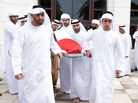 Sheikh Mohamed bin Zayed, Crown Prince of Abu Dhabi and Deputy Supreme Commander of the UAE Armed Forces, helps carry the body of his brother, Sheikh Sultan bin Zayed, after funeral prayers at Sheikh Sultan bin Zayed The First Mosque in Al Bateen.