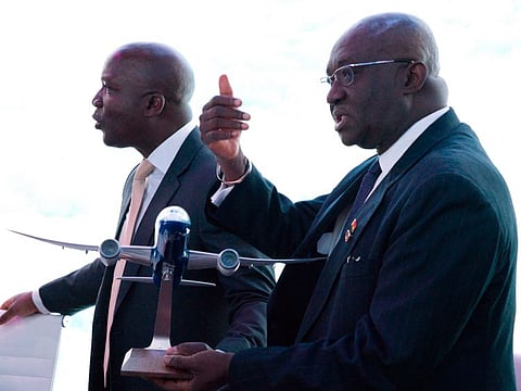 Ghana Aviation Minister Joseph Kofi Adda gestures while holding a model Boeing aircraft at a news conference at the Dubai Airshow in Dubai, United Arab Emirates, Tuesday, Nov. 19, 2019. Ghana said Tuesday that it will launch a national airline early next year with three new Boeing long-haul, widebody 787-9 Dreamliners.