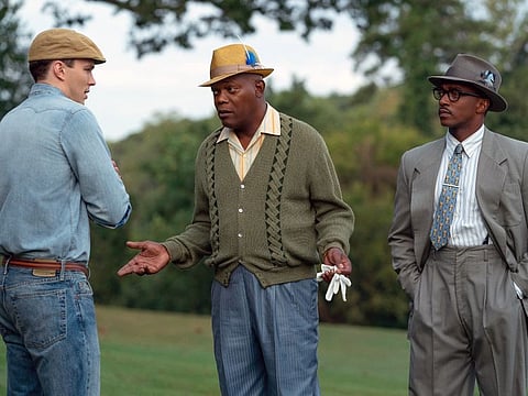 This image released by Apple TV Plus shows, from left, Nicholas Hoult, Samuel L. Jackson and Anthony Mackie in a scene from “The Banker." Apple has canceled the premiere of one of the tech company’s first original films, “The Banker” the day before it was to debut at Los Angeles’ AFI Film Festival. In a statement Wednesday, Apple said that it learned of “some concerns” surrounding “The Banker” and that it needs “some time to look into these matters.” An Apple spokesperson declined to elaborate. (Apple TV Plus via AP)