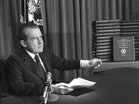 President Richard M. Nixon points to the transcripts of the White House tapes in Washington, after he announced on television that he would turn over the transcripts to House impeachment investigators.