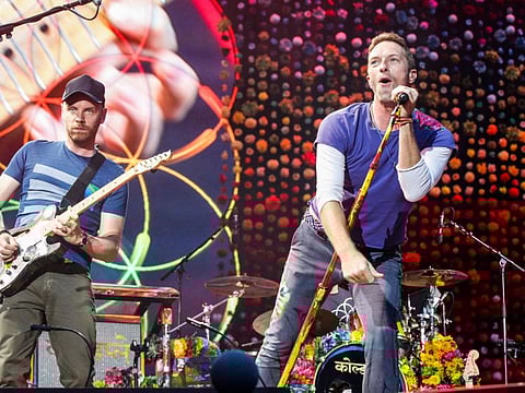 Lead singer of British band Coldplay Chris Martin (R) with guitarist Jonny Buckland perform at The Stade de France Arena in Saint Denis on the outskirts of Paris.