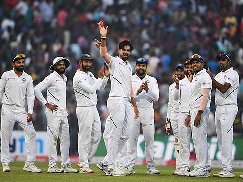 India's Ishant Sharma (centre) reacts as he teammates applaud during the first day of the second Test cricket match of a two-match series between India and Bangladesh at The Eden Gardens cricket stadium in Kolkata on November 22.