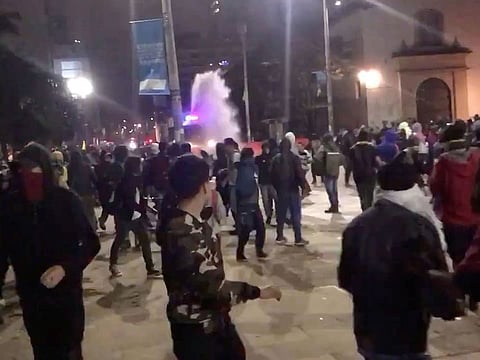 A riot police van fires a water cannon as demonstrators gather on the streets for renewed protests in Bogota, Colombia November 22, 2019 in this still image obtained from social media video.
