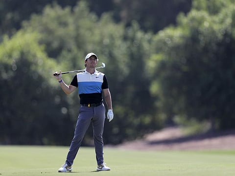 Rory McIlroy follows the trajectory of his short on the third hole during the third round of the DP World Tour Championship golf tournament in Dubai on Saturday.