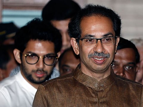 Shiv Sena chief Uddhav Thackeray and his son Aditya Thackeray arrive for a press conference in Mumbai on Saturday.