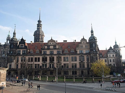 People stand in front of the Residenzschloss, Residence Palace, building with the Green Vault in Dresden Monday, Nov. 25, 2019. Authorities in Germany say thieves have carried out a brazen heist at Dresden’s Green Vault, one of the world’s oldest museum containing priceless treasures from around the world.