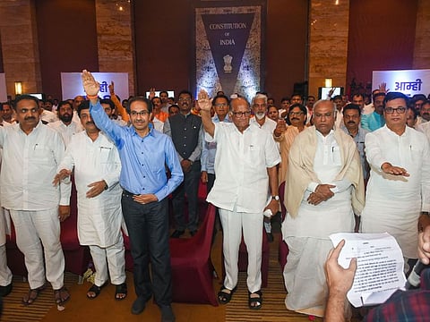 Senior Congress leader Mallikarjun Kharge, NCP chief Sharad Pawar and Shiv Sena President Uddhav Thackeray along with NCP, Congress and Shiv Sena MLAs take a pledge during a gathering to display their strength, at Grand Hyatt Hotel in Mumbai, Monday, Nov. 25, 2019.