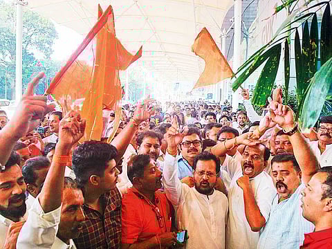 Shiv Sena supporters shout slogans as they celebrate after the resignation of BJP leader Devendra Fadnavis as Maharashtra Chief Minister, in Mumbai on Tuesday.