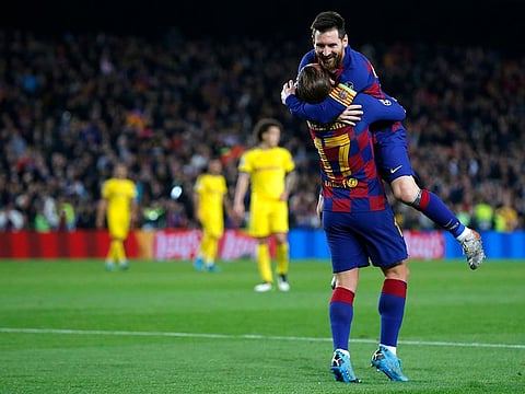 Lionel Messi celebrates with Antoine Griezmann.
