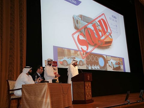 People bid at a car auction of Abu Dhabi Judicial Department at the Emirates Palace Hotel in Abu Dhabi on Wednesday evening.