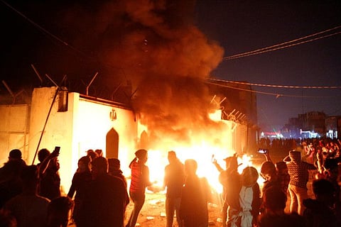 Demonstrators set fire in front of the Iranian consulate, as they gather during ongoing anti-government protests in Najaf, Iraq November 27, 2019