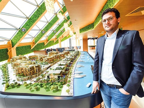 Talal Al Gaddah is CEO of MAG Property Development posing with the model of the groups Healthcare City project at the MAG office located at the Emirates Financial Tower DIFC, Dubai.