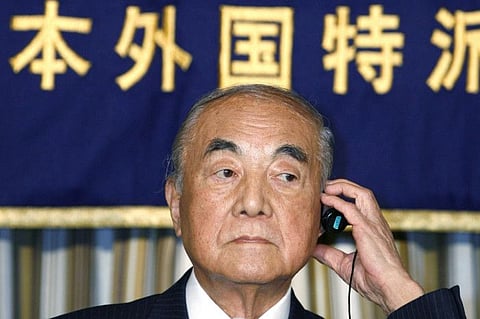 In this March 23, 2007 file photo, former Japanese Prime Minister Yasuhiro Nakasone adjusts earphone during a press conference in Tokyo.