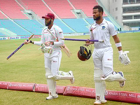 West Indies' Shai Hope (L) and John Campbell walk with stumps after the third day of the only cricket Test match against Afghanistan at the Ekana Cricket Stadium in Lucknow on November 29, 2019.
