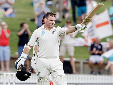 New Zealand's Tom Latham celebrates after scoring a century during play on day one of the second cricket test against England at Seddon Park in Hamilton, New Zealand, on November 29, 2019.