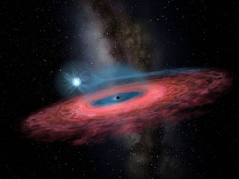Image used for illustrative purposes only: This handout received from the Beijing Planetarium via the China Academy of Sciences on November 26, 2019 shows a rendering by artist Yu Jingchuan of the accretion of gas onto a stellar black hole from its blue companion star, through a truncated accretion disk. Astronomers have discovered a black hole in the Milky Way so huge that it challenges existing models of how stars evolve, researchers announced on November 28.