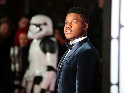 Actor John Boyega poses for photographers as he arrives for the European Premiere of 'Star Wars: The Last Jedi', at the Royal Albert Hall in central London, Britain, December 12, 2017.