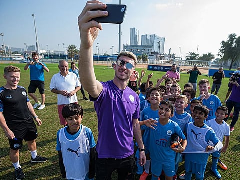 City's Laporte takes a selfie with City Football Schools youngsters.