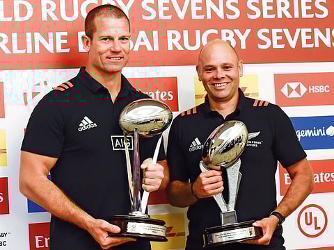 Tony Philp, High Performance Sevens Manager of All Blacks men's team (left) and Cory Sweeney, coach of All Blacks women’s team pose with the winners' trophies at the official press conference of Emirates Airline Dubai Rugby Sevens on Wednesday.