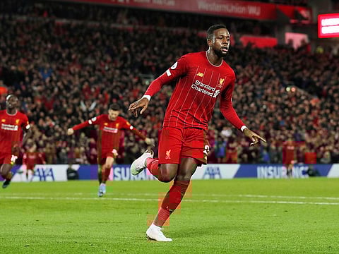 Liverpool's Divock Origi celebrates scoring their third goal.