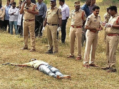 The body of one of the accused in the rape and murder of the woman veterinarian seen at the spot where they were killed in an encounter with the police, in Hyderabad