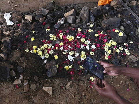 An Indian man visit the site were the veterinarian's body was found after she was allegedly gang rape and burnt in Shadnagar some 50 kilometers or 31 miles from Hyderabad, India, Friday, Dec. 6, 2019. An Indian police official says four men accused of raping and killing a woman in southern India have been fatally shot by police. (AP Photo/Mahesh Kumar A.)