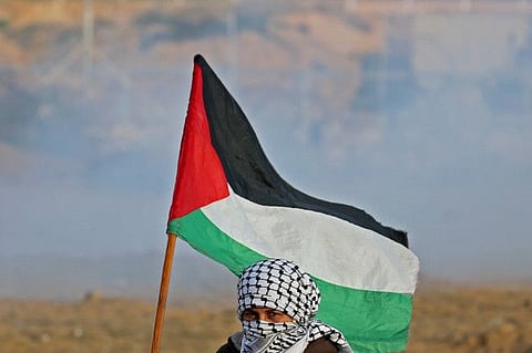 A Palestinian demonstrator at the Israel-Gaza border fence during an anti-Israel protest in the southern Gaza Strip on December 6, 2019.