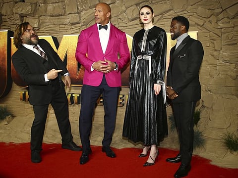 Actors Jack Black, from left, Dwayne Johnson, Kevin Hart and Karen Gillan pose for photographers upon arrival at the premiere of the film 'Jumanji The Next Level', in central London, Thursday, Dec. 5, 2019.