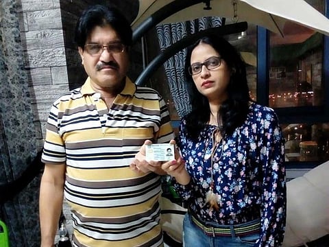 Kajal with her husband Rasheed Khan showing her new Pakistani identity card at their house in Sharjah.