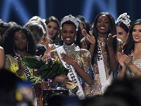 Newly crowned Miss Universe 2019 South Africa's Zozibini Tunzi poses on stage with contestants after the 2019 Miss Universe pageant at the Tyler Perry Studios in Atlanta, Georgia on December 8, 2019. / AFP / VALERIE MACON
