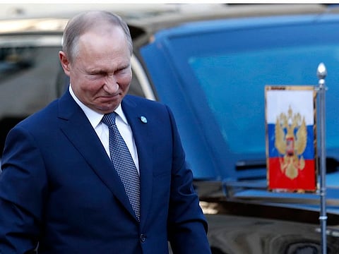Russian President Vladimir Putin grimaces as he arrives at the Elysee Palace Monday, Dec. 9, 2019 in Paris.