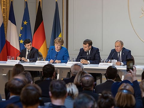 Ukrainian President Volodymyr Zelensky, German Chancellor Angela Merkel, French President Emmanuel Macron and Russian President Vladimir Putin giving a press conference after a summit on Ukraine at the Elysee Palace, in Paris.