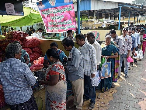 People stand in a queue to buy onions for Rs.25/kg at a subsidy store in a vegetable market in Vijayawada on Thursday.
