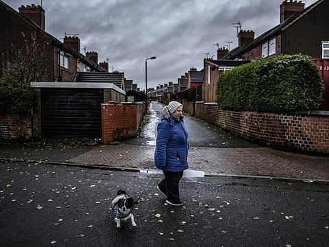 A resident walks her dog past homes originally built for the families of miners — the local coal mine closed in 1993 — in Shirebrook, England, on November 17, 2019. As Britain heads for an election, a reporter’s two-week tour across Britain found a country where, for all sorts of reasons, all sorts of people felt alienated and unmoored.