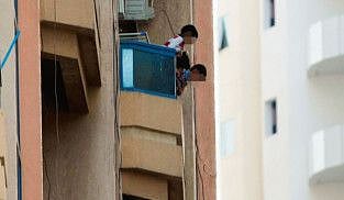 Kids leaning dangerously from balcony of an apartment in Al Nahda, Sharjah
