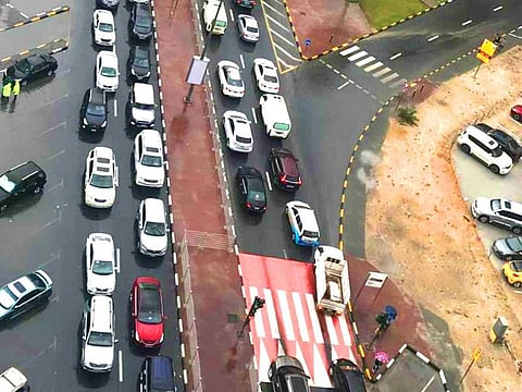 Al Intifada Street in Sharjah faced gridlocked traffic as motorists and pupils braved the heavy rain on Wednesday morning.