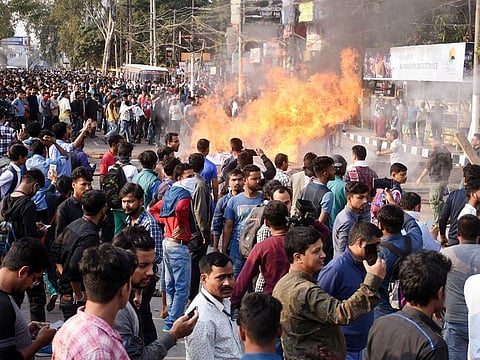 Protesters burn wooden blocks and hoardings during a protest against the Citizenship (Amendment) Bill 2019, in Guwahati on Wednesday.
